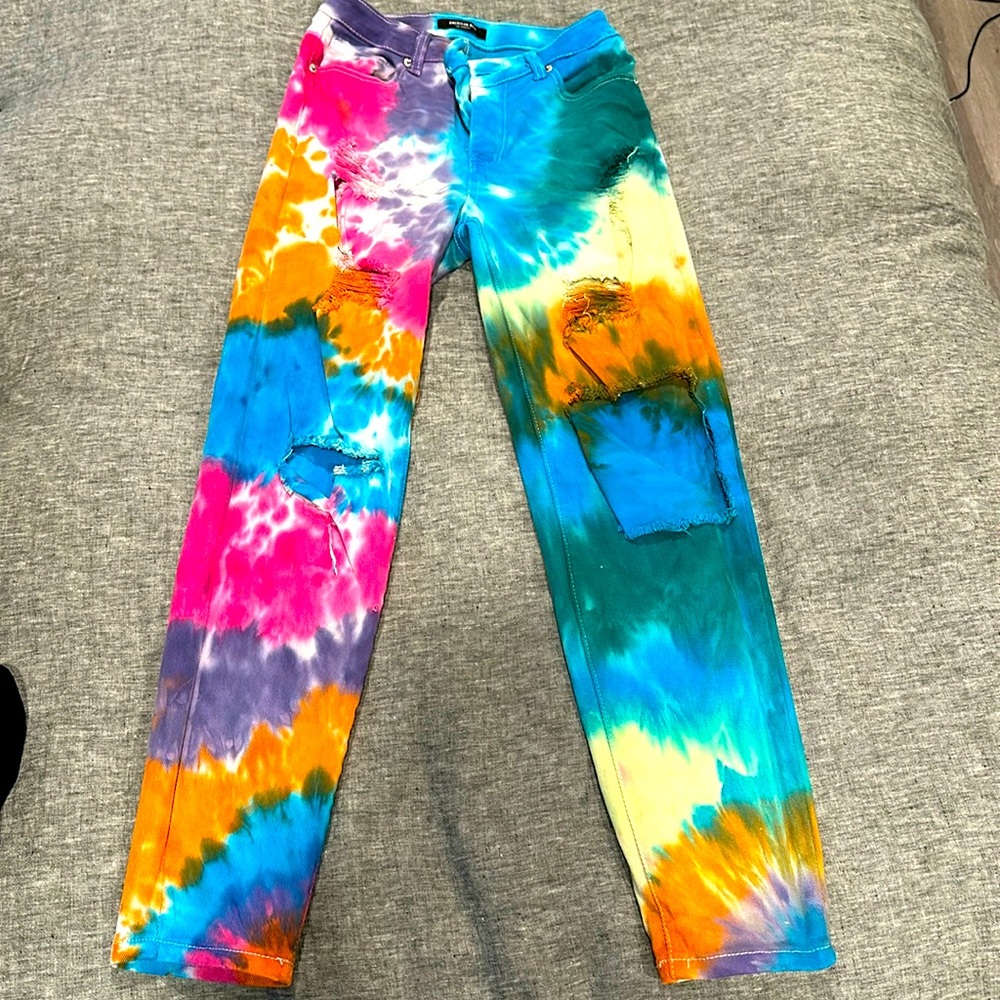 Tie dye, distressed boyfriend fit jeans.